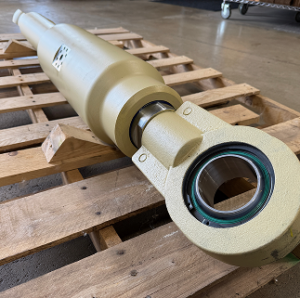 A large mechanical component is placed on a wooden pallet.